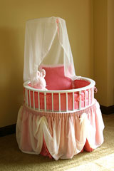 round crib with white canopy